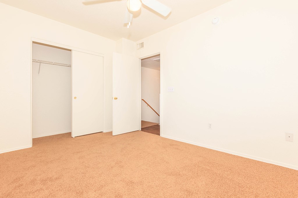 an empty room with white walls and a closet