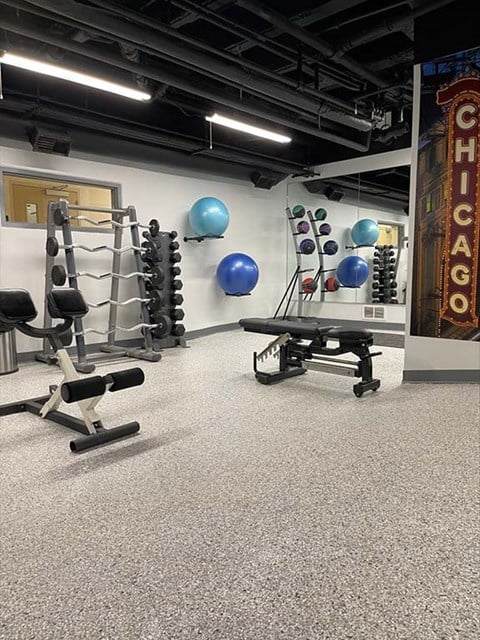 a gym with weights and exercise equipment in a room
