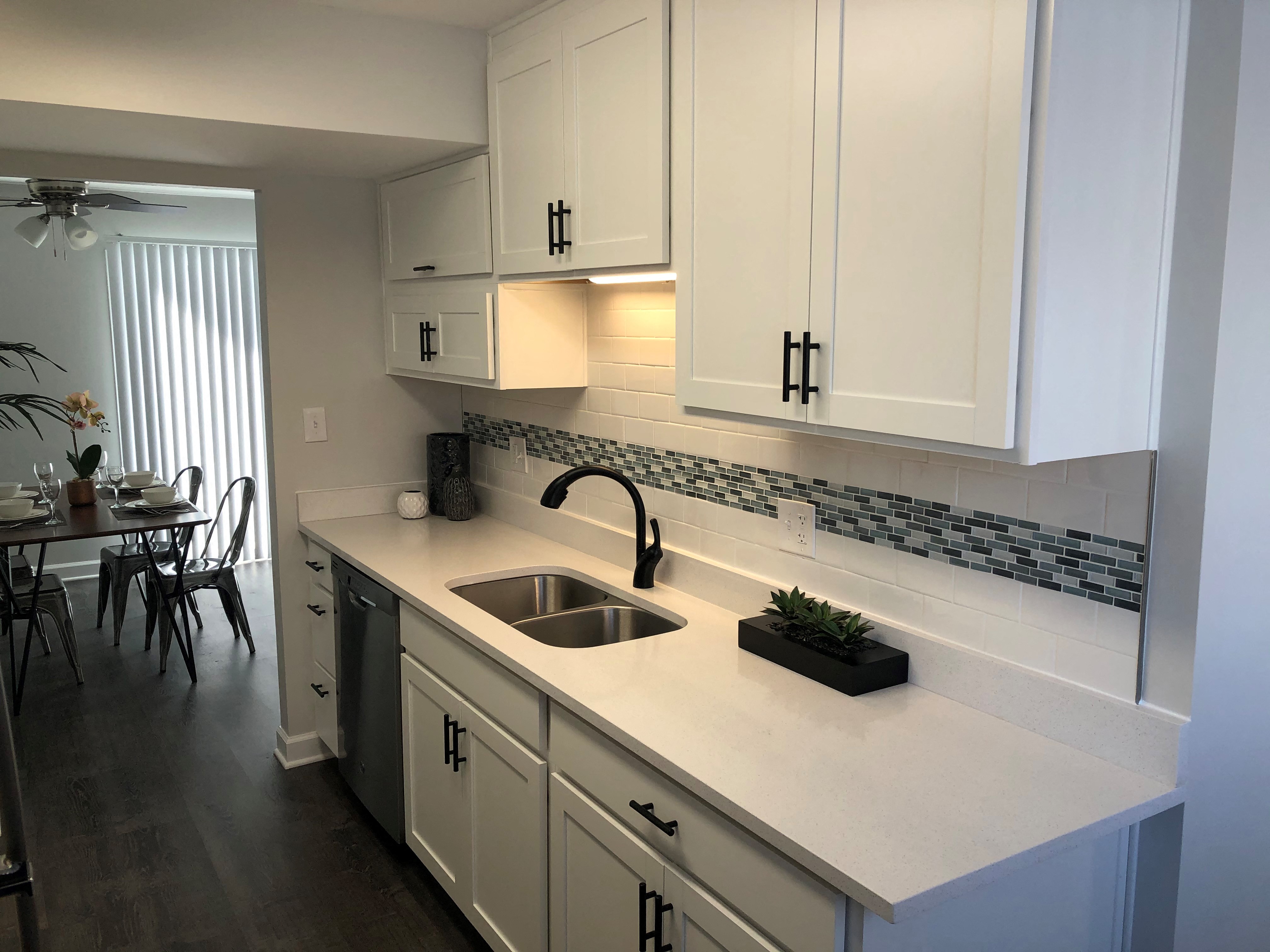 a kitchen with white cabinets and a sink