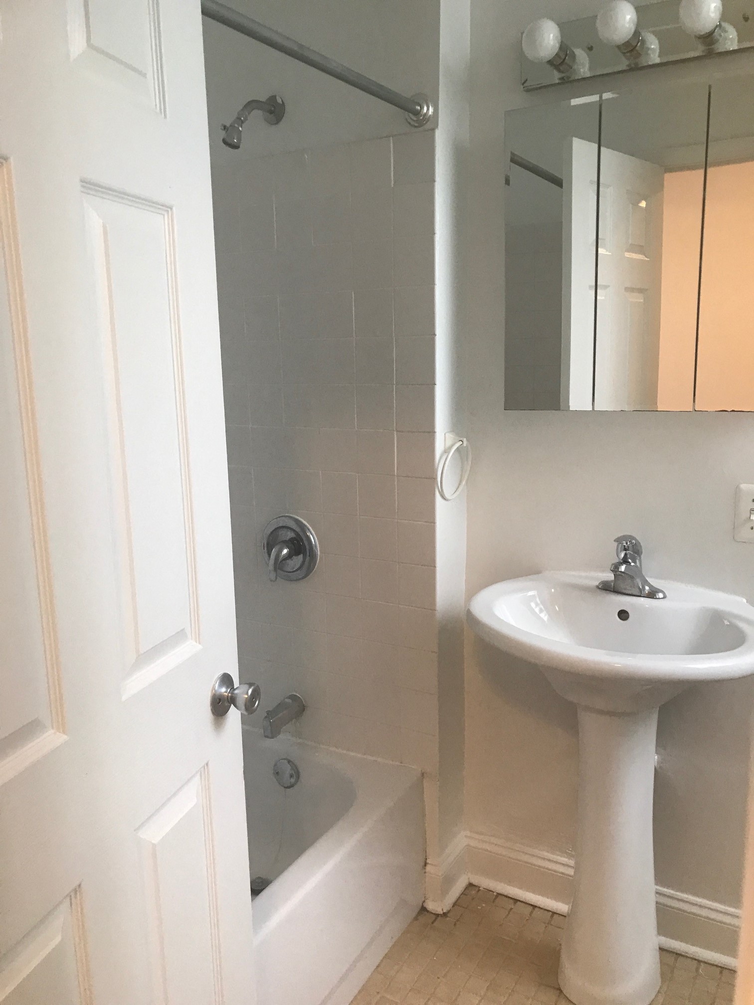 a small bathroom with a sink and a shower