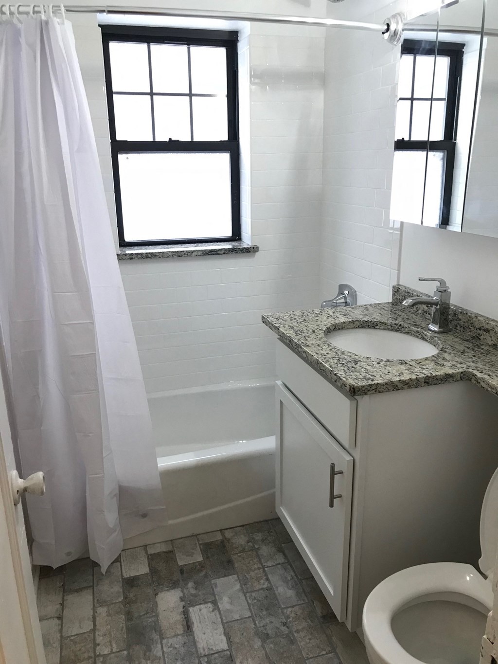 a small bathroom with a sink toilet and shower