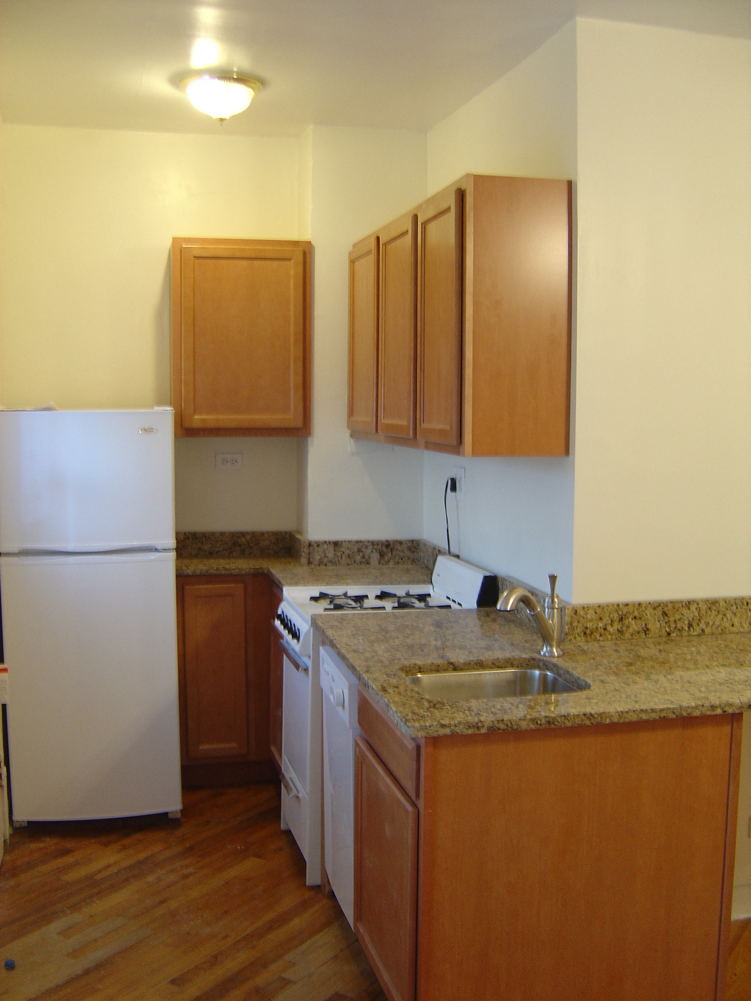 a kitchen with a sink and a refrigerator