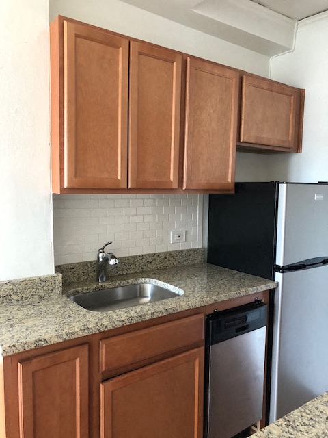a kitchen with wooden cabinets and a sink
