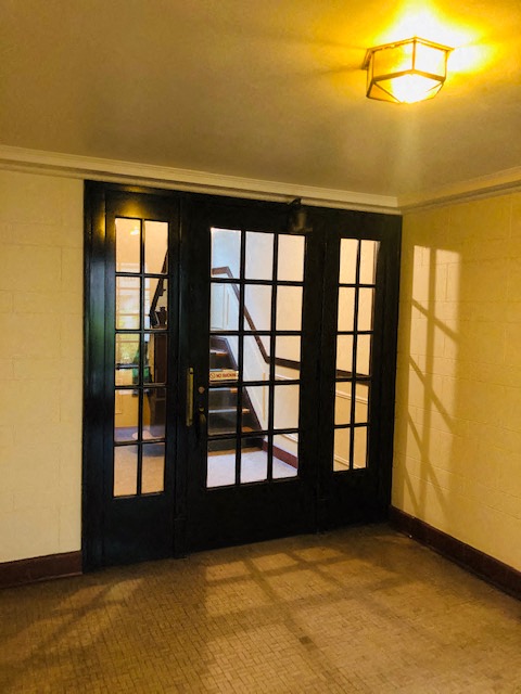 a living room with a door and a staircase