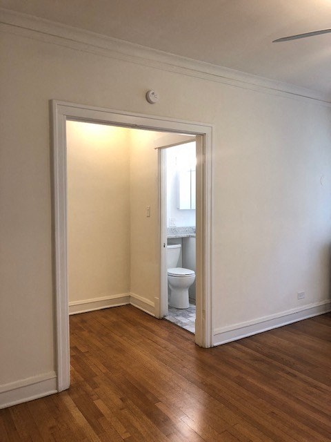 an empty room with a door open to a bathroom