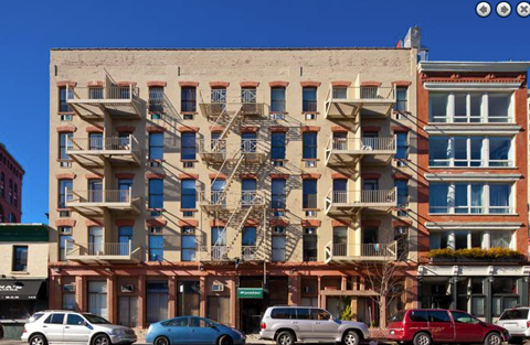 a large brick building with cars parked in front of it