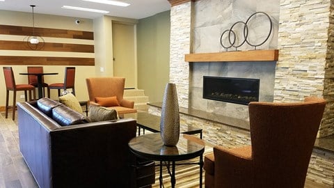 a living room with a fireplace and a table and chairs