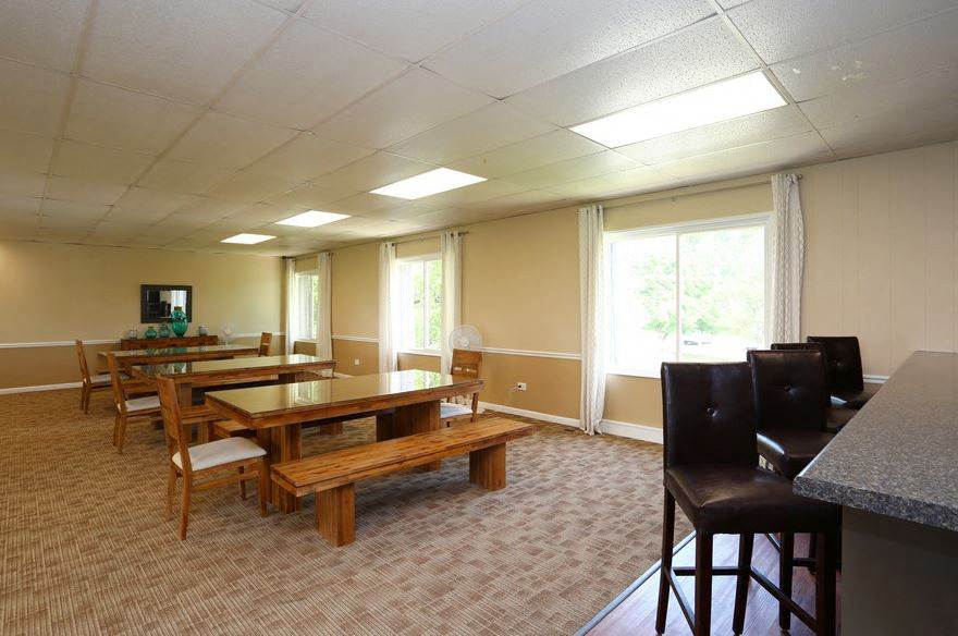 a dining room with a table and chairs