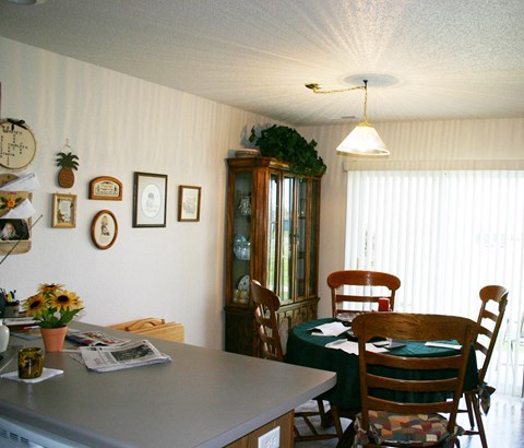 A dining room with a table set for four.