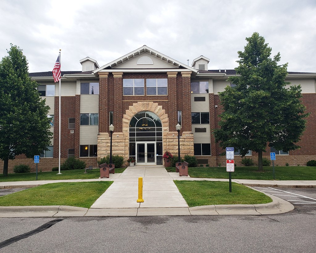 the front of a building with an flag