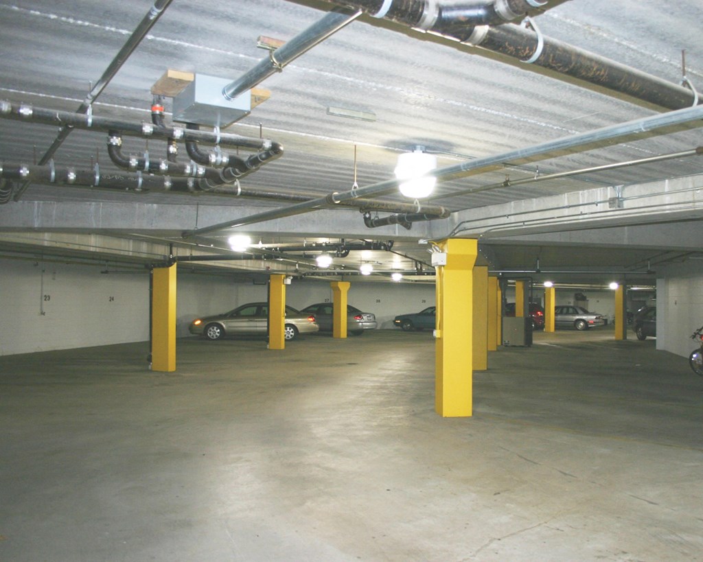the inside of a parking garage with cars in it