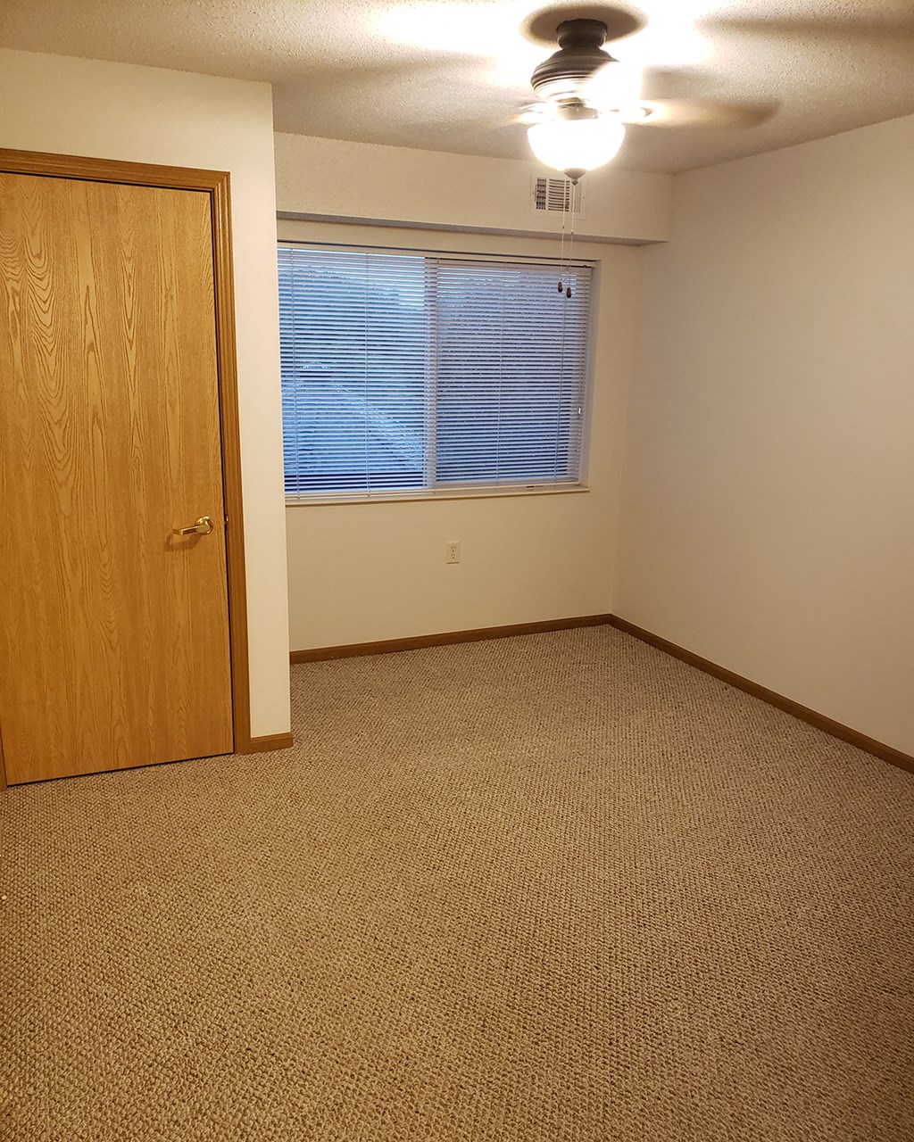 an empty room with a door and a window