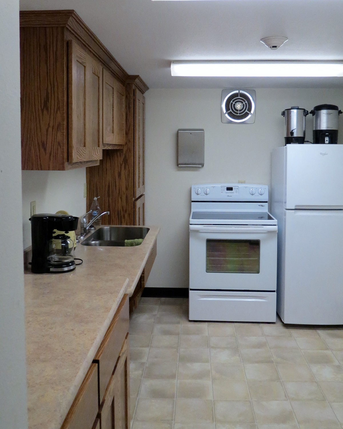 a kitchen with a stove refrigerator and a sink