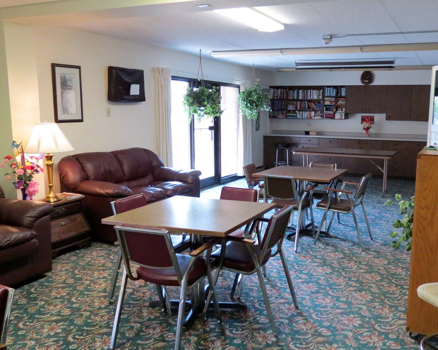 a living room with couches and tables and chairs