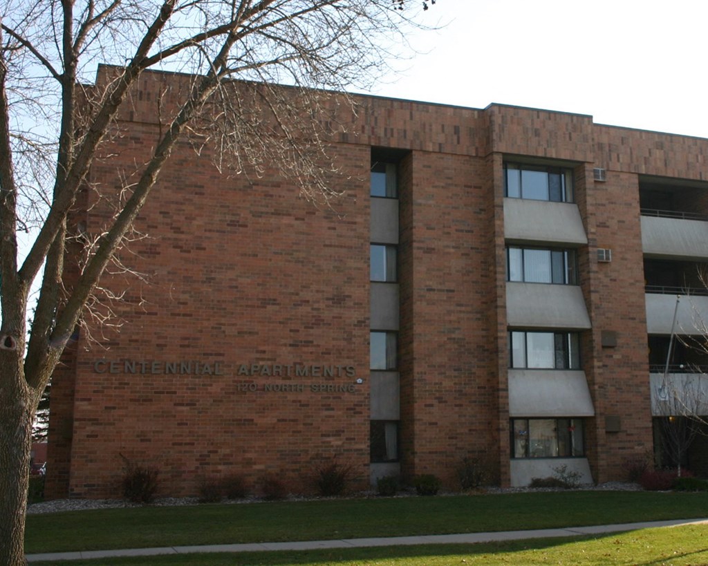 a brick building with a tree in front of it