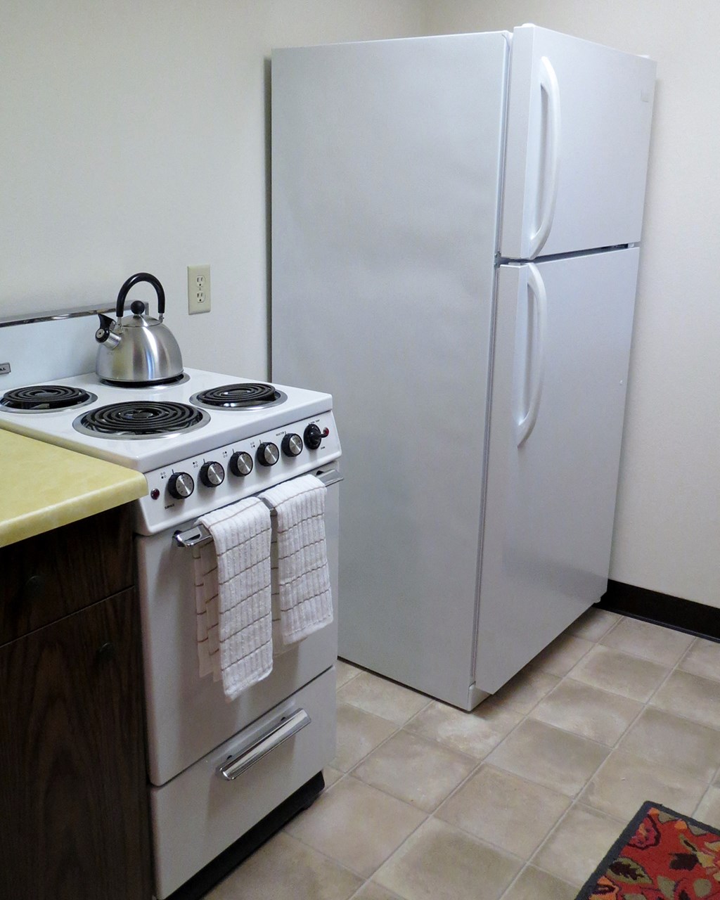 a small kitchen with a stove and a refrigerator