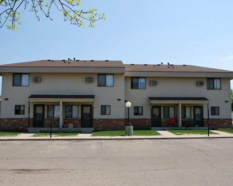 a large apartment building with a street in front of it