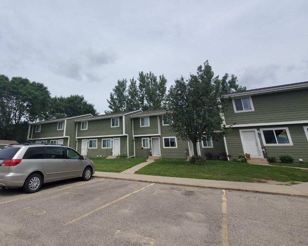 a car parked in a parking lot in front of houses