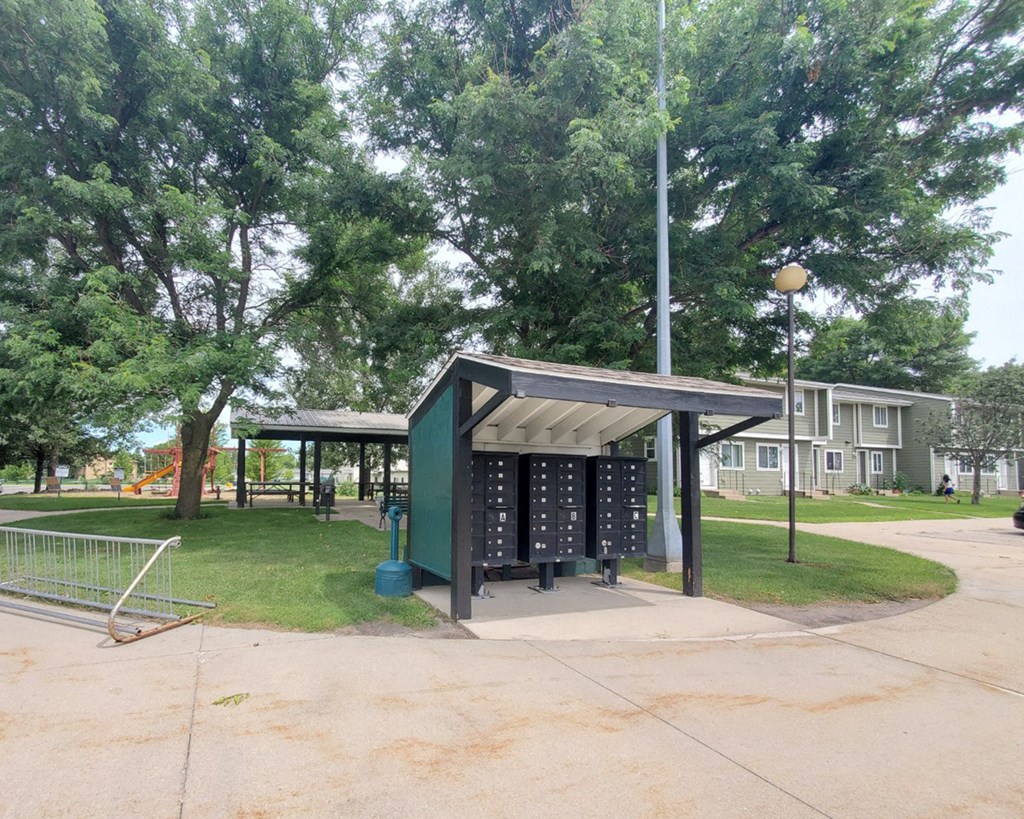 a pavilion in a park with a playground and trees