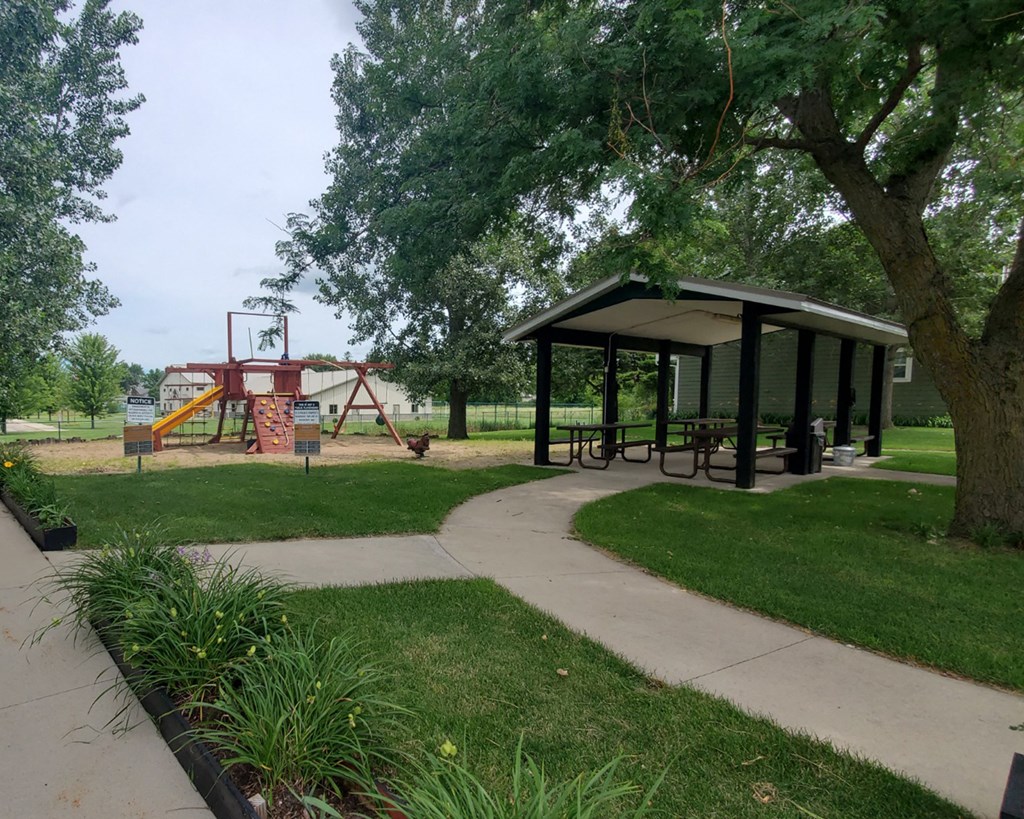 a picnic shelter and playground in a park