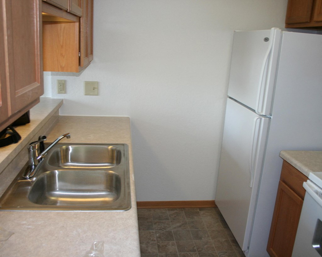 a kitchen with a sink and a refrigerator