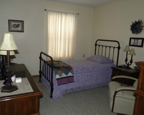 a bedroom with a bed and a dresser