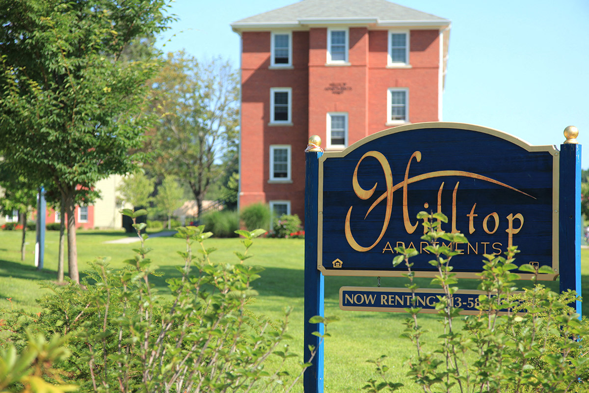 a sign in front of an apartment building