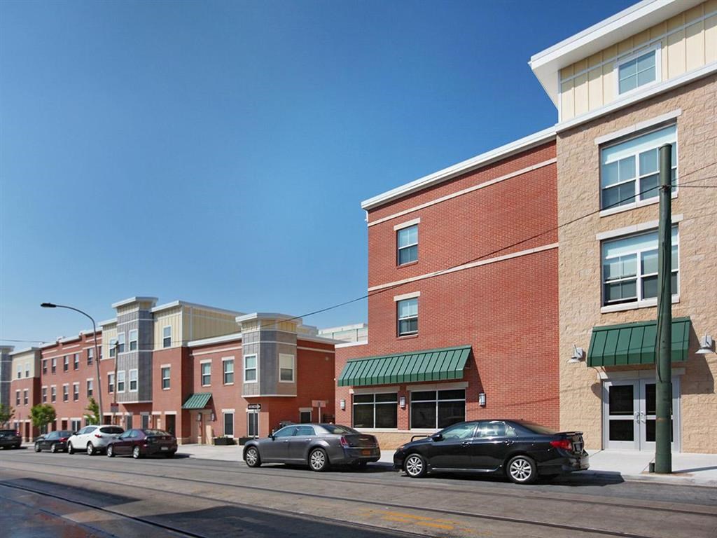 a city street with cars parked in front of buildings