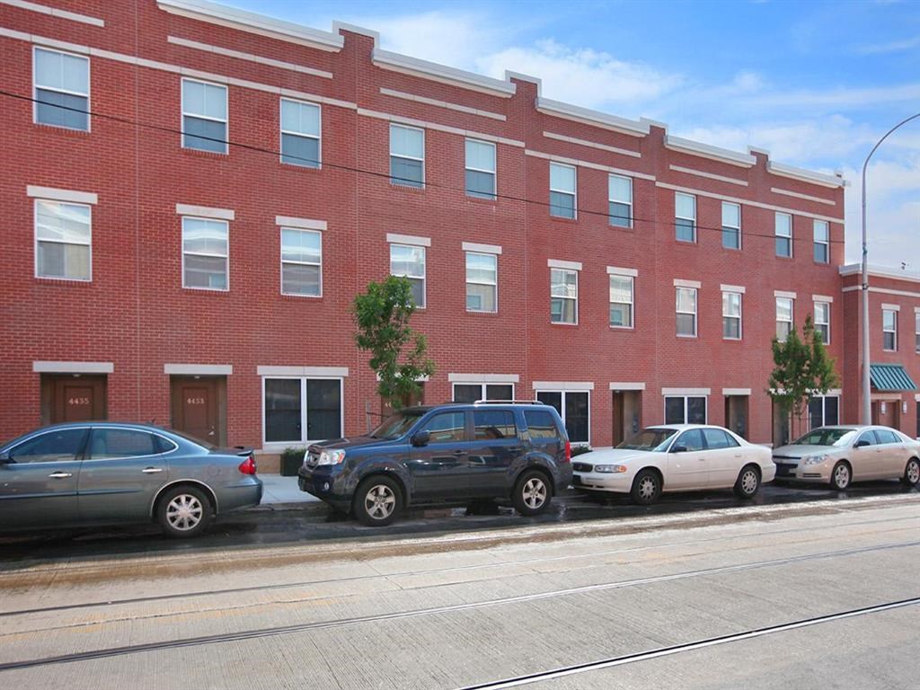 a red brick building with cars parked in front of it