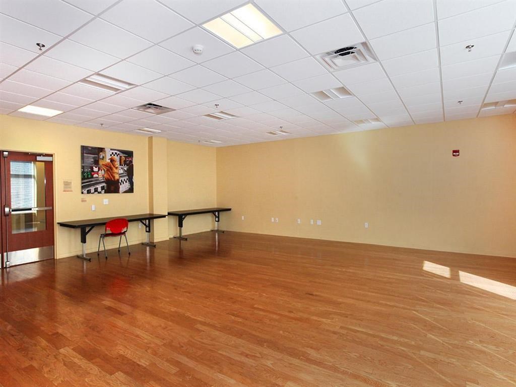 a large room with a wood floor and a table