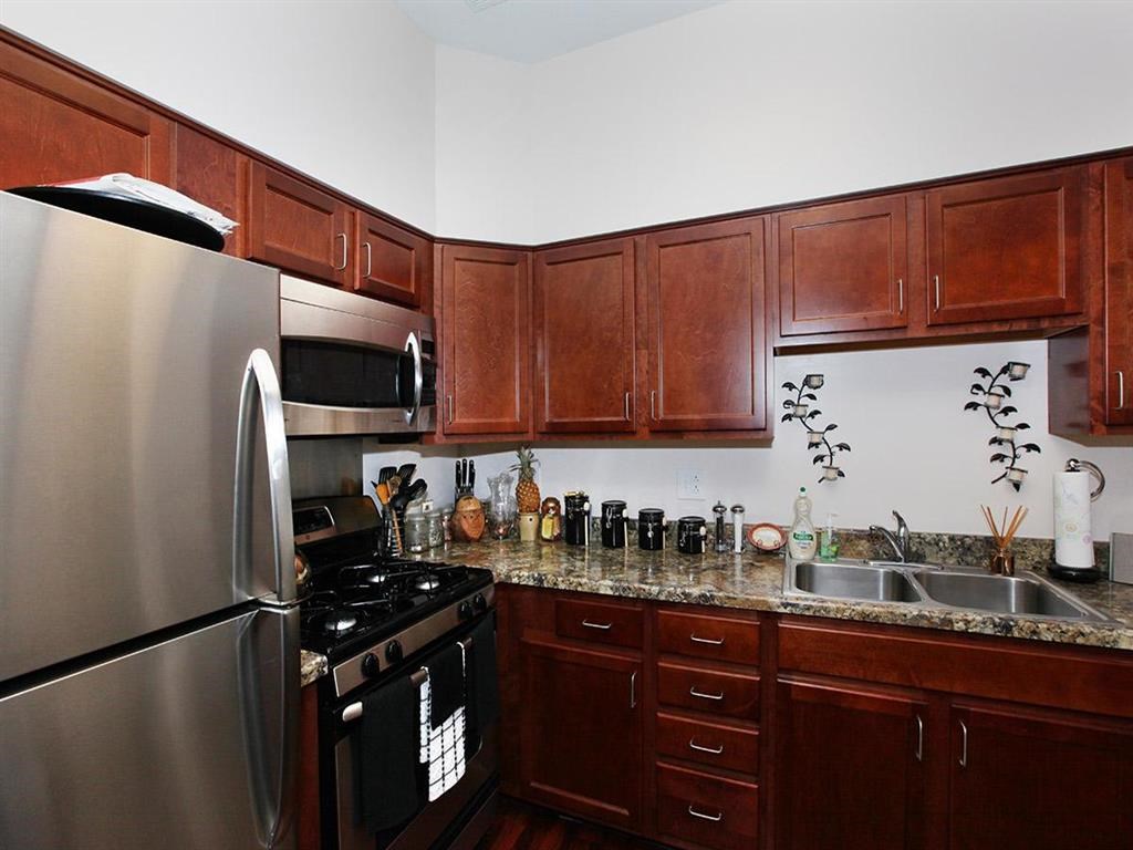 a kitchen with stainless steel appliances and wooden cabinets
