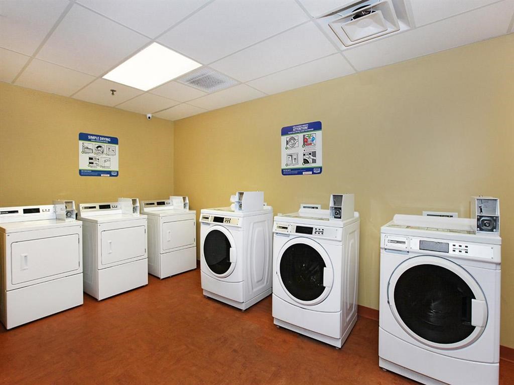 a group of washers and dryers in a laundry room