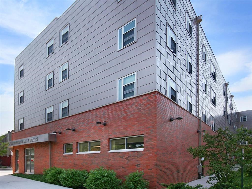 a brick building with a silver building on top of it