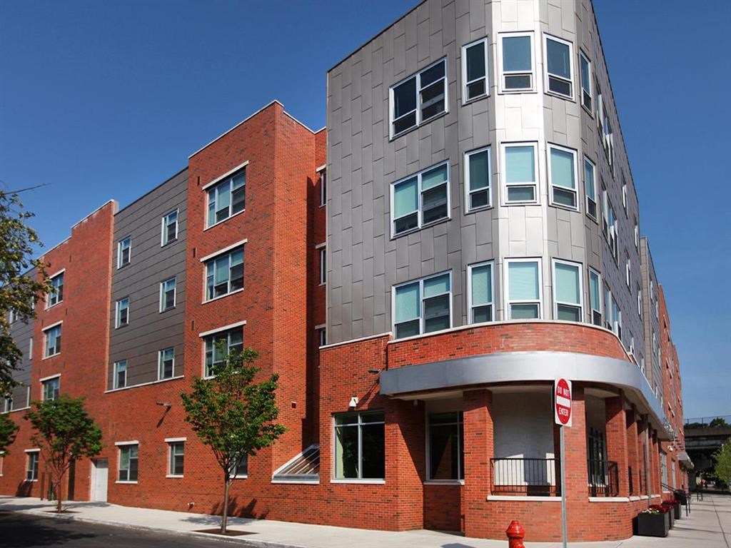 a red brick building with a silver building next to it