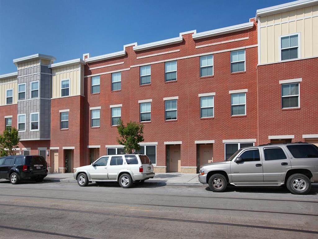 a brick building with cars parked in front of it