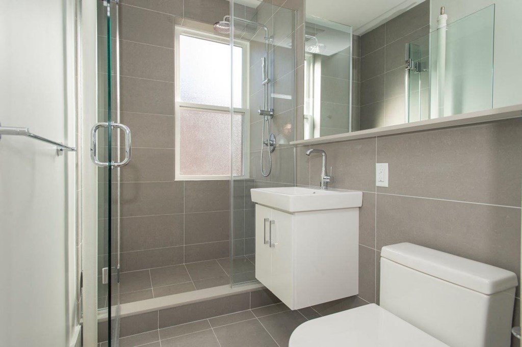 a bathroom with a sink toilet and a shower