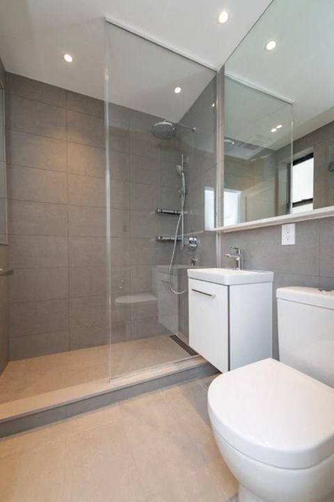a bathroom with a toilet and a shower