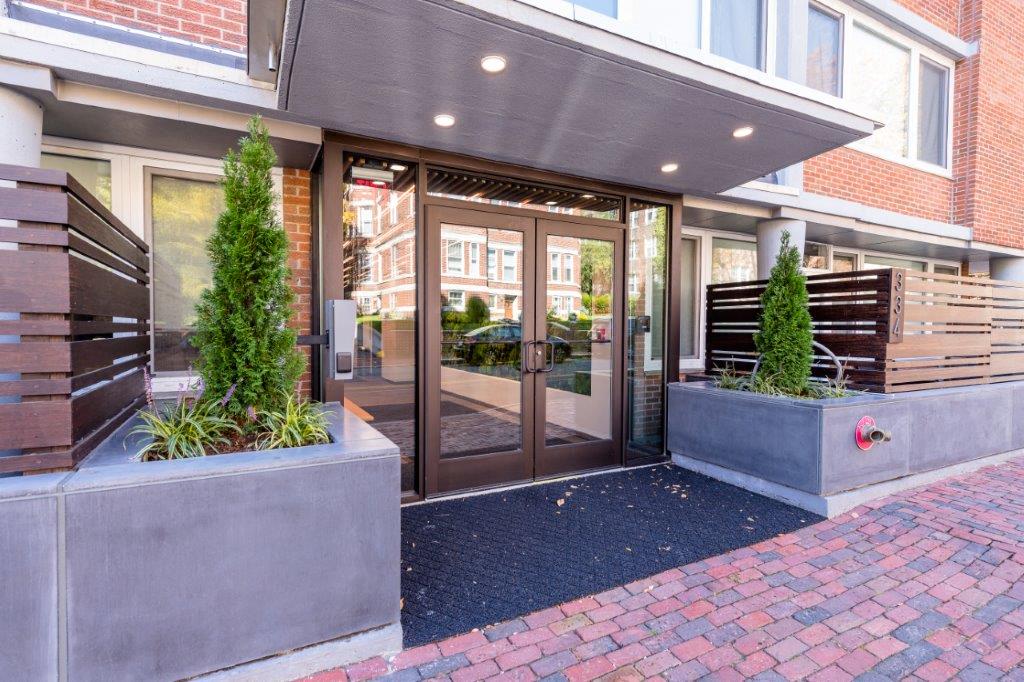 the front entrance of a building with glass doors