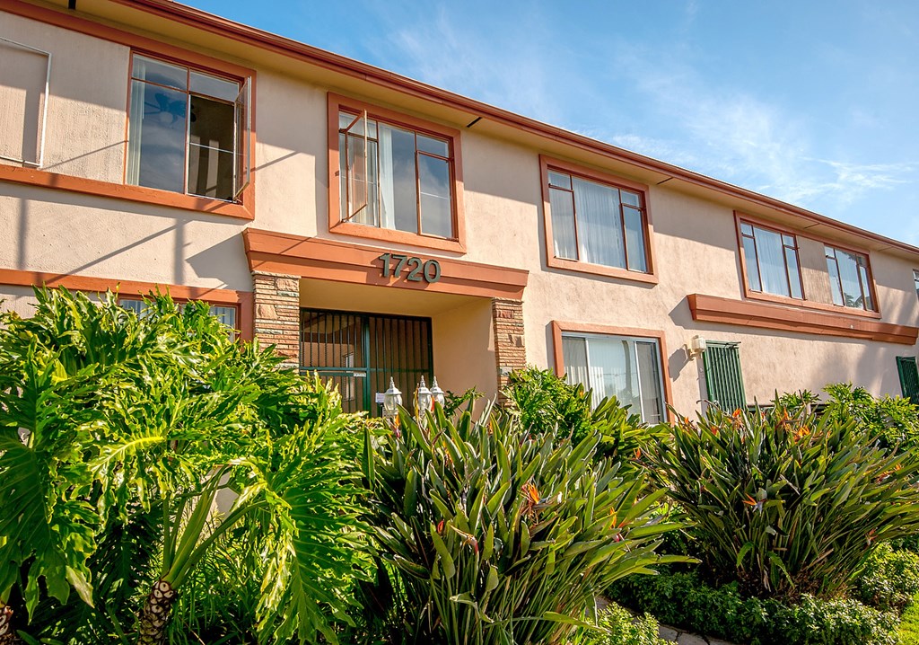 a building with the number 790 on it surrounded by plants