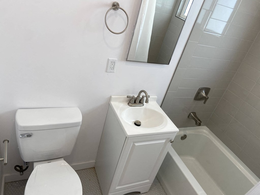 a white bathroom with a toilet sink and tub