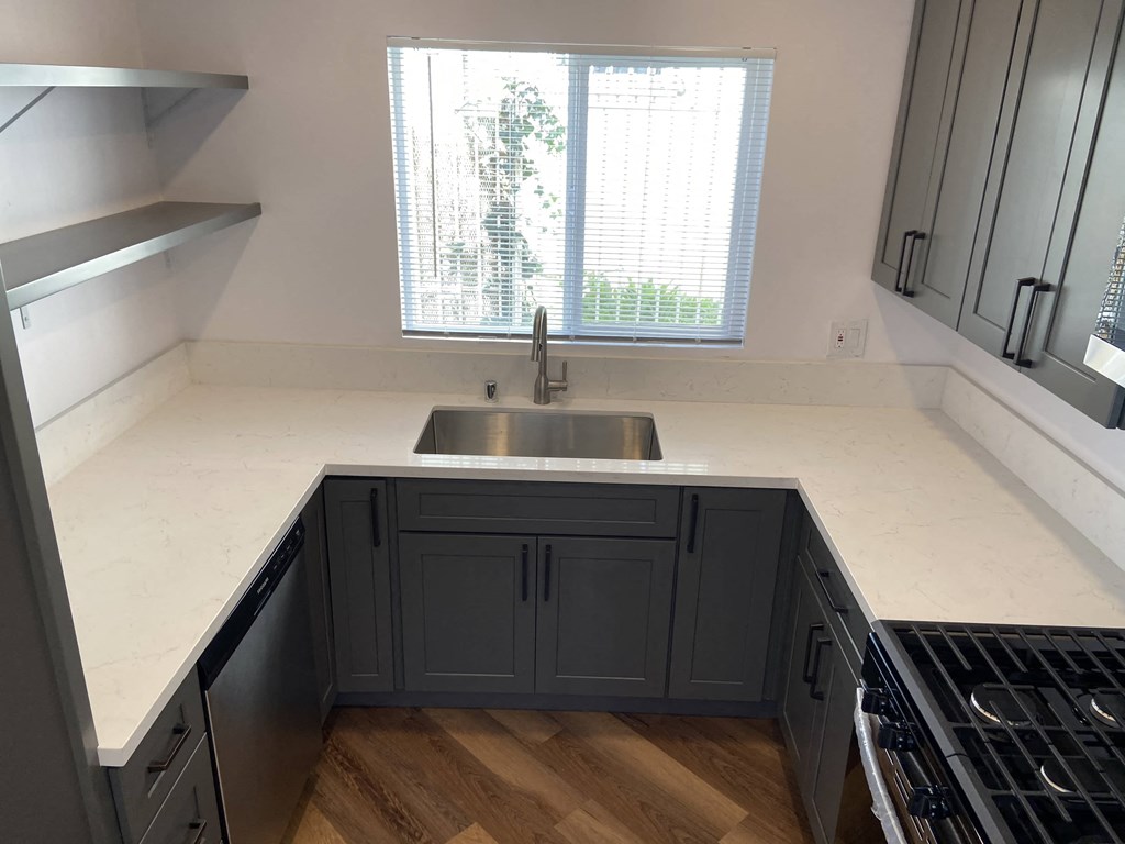 a kitchen with a sink and a window