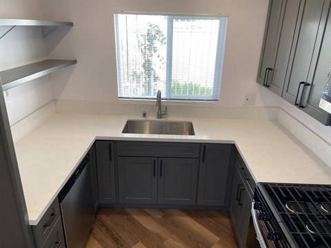 a kitchen with a sink and a window