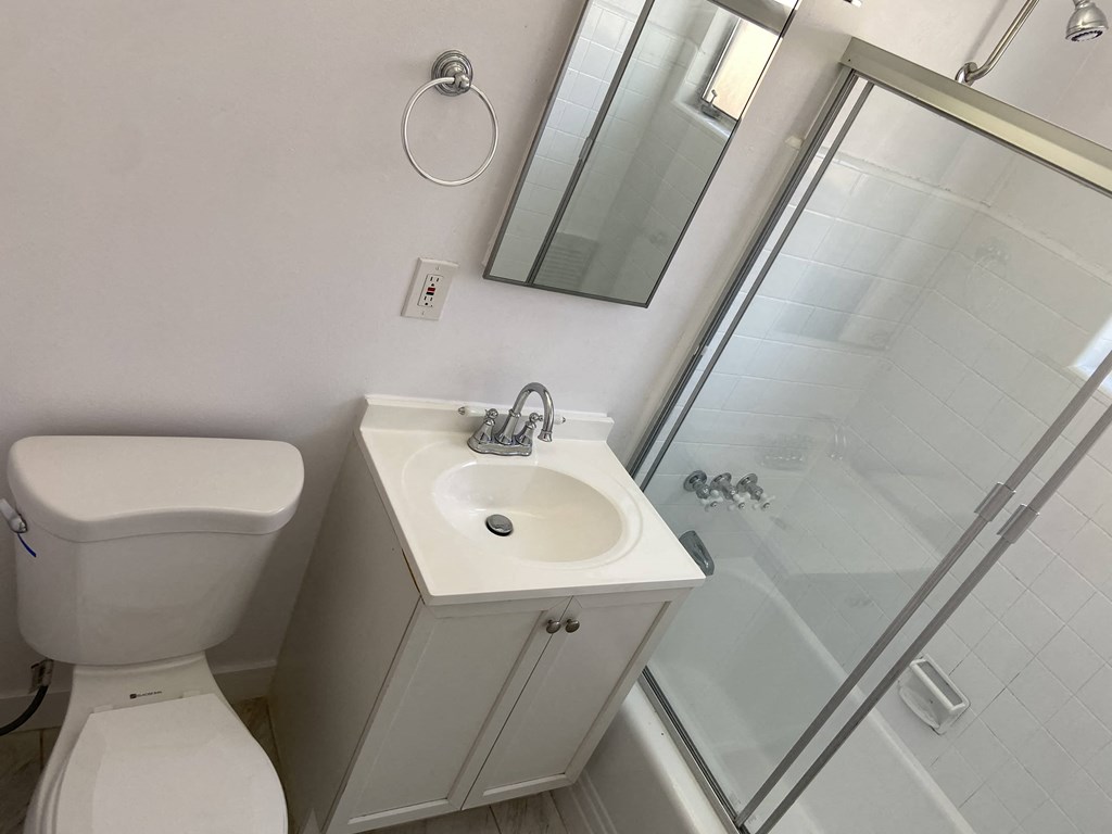 a small bathroom with a toilet sink and shower