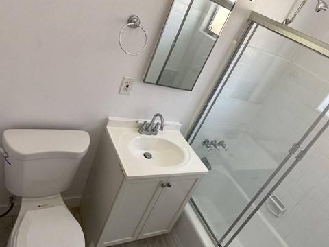 a small bathroom with a toilet sink and shower