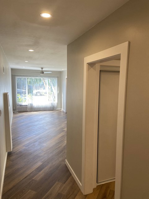 a renovated living room and dining room with wood flooring