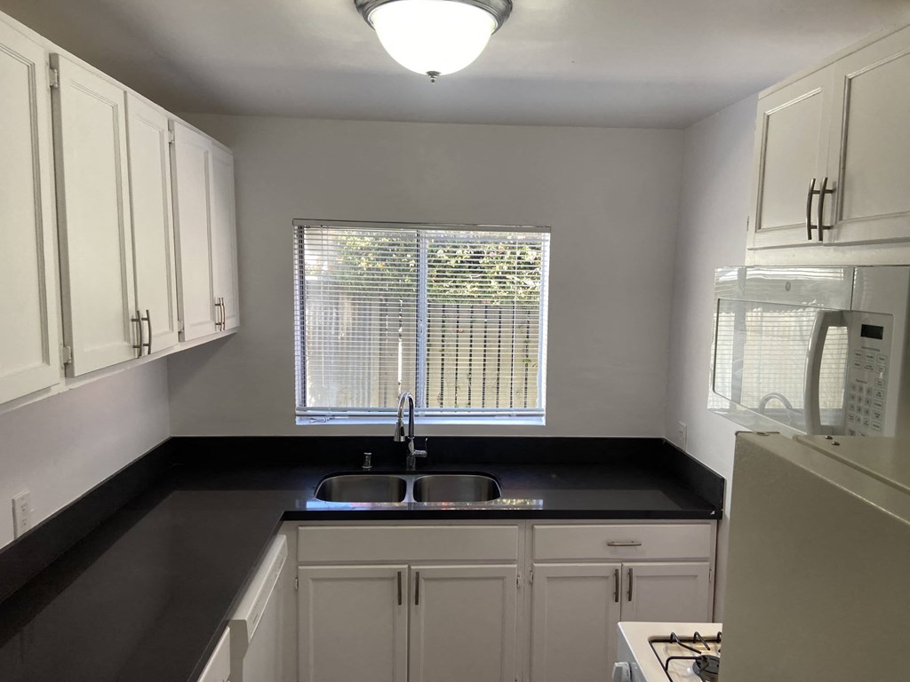a kitchen with a sink and a window
