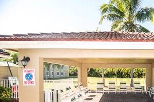 outdoor covered pool area with pool chairs_Westview Gardens Apartments Miami, Florida