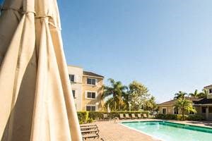 outdoor pool and pool area with tables and chairs_Westview Gardens Apartments Miami, Florida