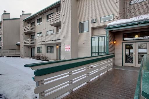 a building with a balcony and a guard rail in the snow