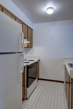 a kitchen with a stove and a refrigerator